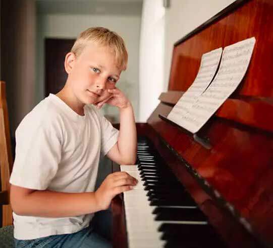 Boy playing a piano